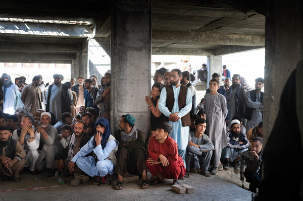 Afghans wait for food assistance from the World Food Programme in Kabul in October.