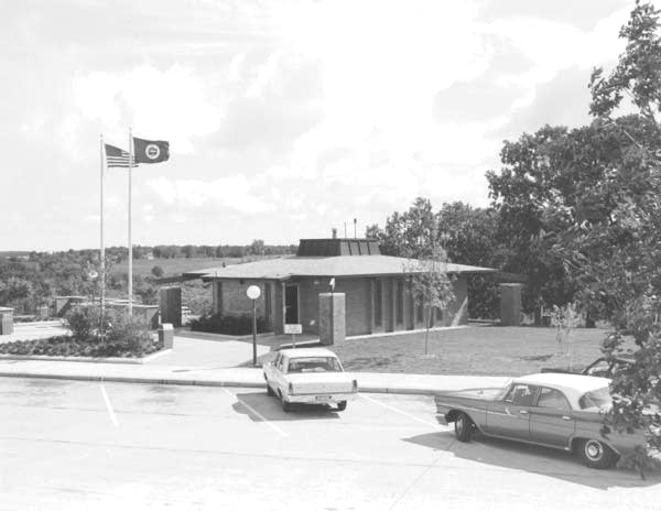 A black and white photo of a rest stop.