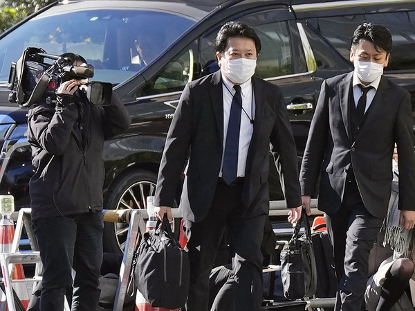 Investigators enter the headquarters of major advertising company Dentsu in Tokyo Friday, Nov. 25, 2022 as the investigation into corruption related to the Tokyo Olympics widened. (Kyodo News via AP)