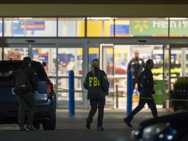 Law enforcement, including the FBI, work the scene of a mass shooting at a Walmart on Wednesday in Chesapeake, Va.