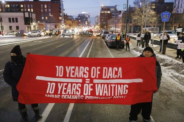 A red sign reads 10 years of DACA equals 10 years of waiting