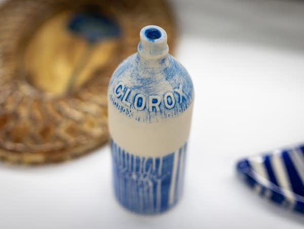 A ceramic clorox bottle with blue glaze