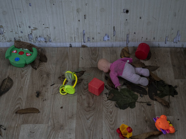 Toys and a doll lay on the floor of a playhouse in the courtyard of Kherson regional children's home in Kherson, southern Ukraine, Friday, Nov. 25, 2022.