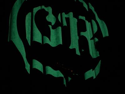 Behind the stage, a felt background featured a projected "GR" Logo