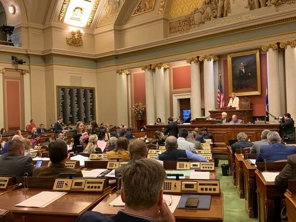 congress people sitting and listening to proposals at a podium