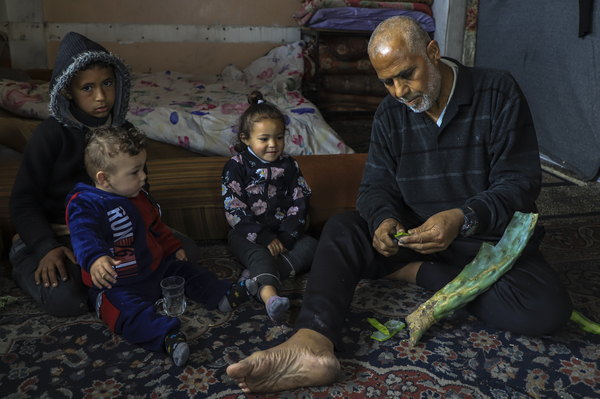 Marwan Saleh, 59, peels a succulent for his family to eat. They have run out of everything else.