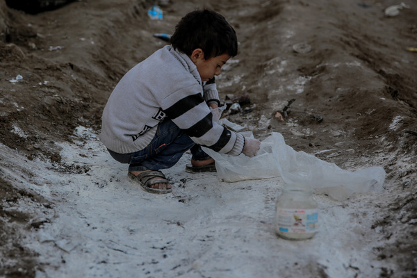 A child on Al Rashid Street tries to gather flour that spilled from one of the rare aid convoys that entered northern Gaza from Kerem Shalom crossing.
