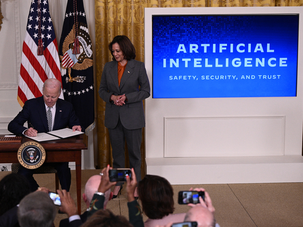 Vice President Harris watches as President Biden signs an executive order on artificial intelligence on Oct. 30. On Thursday, the Biden administration issued new rules on how government agencies can implement AI.