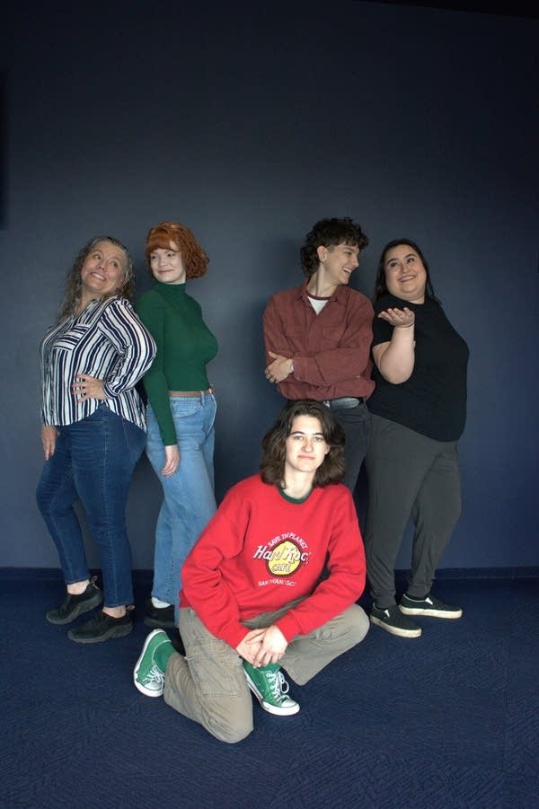 Five people pose for a theater promotional photo.