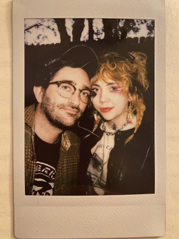 A polaroid of a man and woman standing close to each other