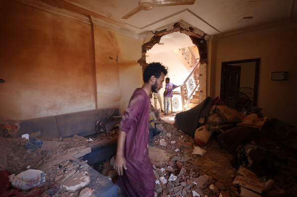 Muhammad inspects his house after it was hit by a missile.