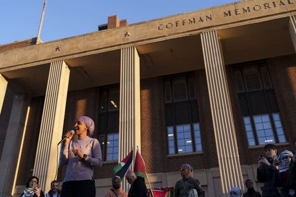A woman speaks in front of a student union