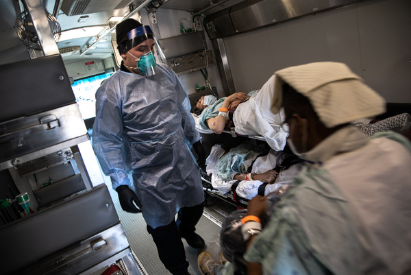 An EMT wearing personal protective equipment prepares to unload COVID-19 transfer patients in the early days of the pandemic. The Biden Administration has just announced a new program aimed at preventing the next pandemic.