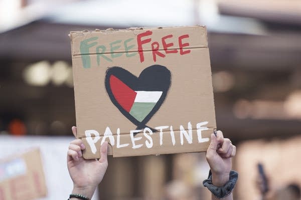 A person holds a sign that says free free palestine