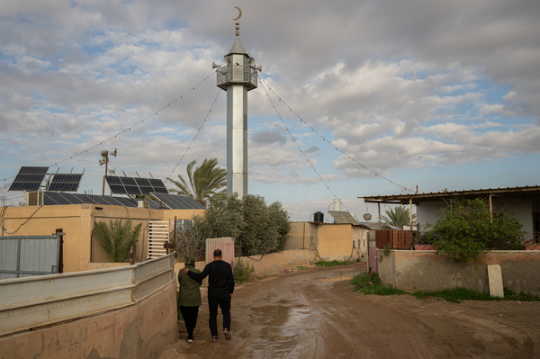 Mohammad Abu Queider and his wife Mayada walk through al-Zarnuq.