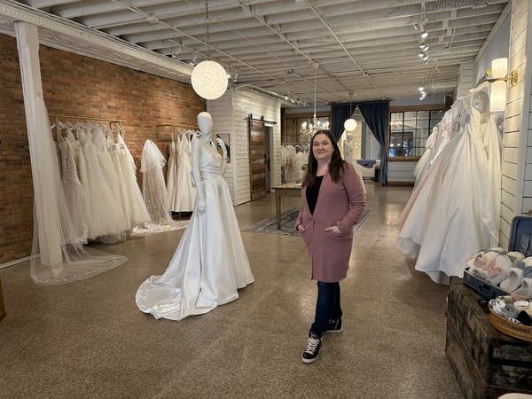 A person stands in a bridal shop