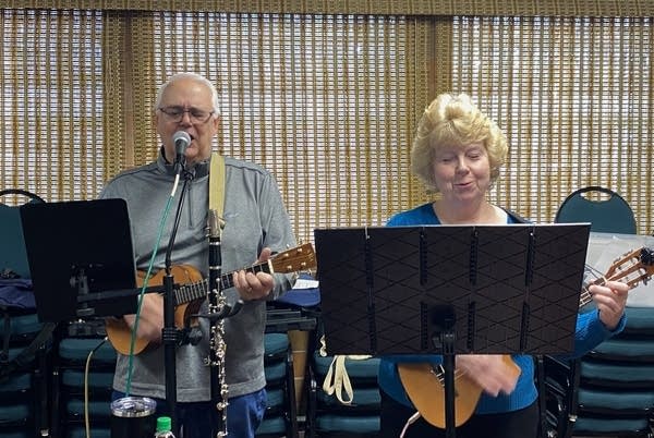 man and woman play ukulele