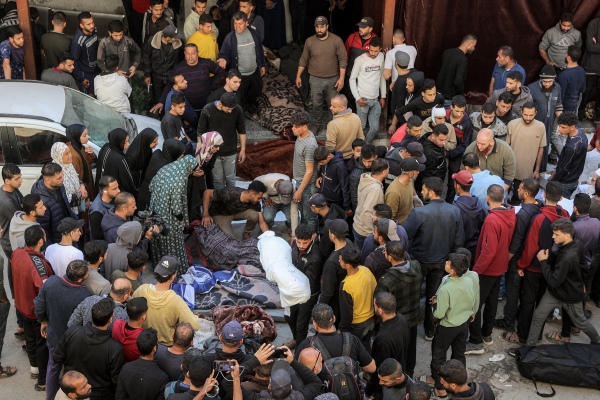 People gather at Ahli Arab hospital, also known as the Baptist hospital, to mourn and bid farewell to the bodies of victims killed in Israeli bombardment, in Gaza City on Tuesday. Israel unleashed its most intense strikes on the Gaza Strip since a January ceasefire with Israel saying it was targeting Hamas fighters., with rescuers reporting 220 people killed, and Hamas accusing Benjamin Netanyahu of deciding to "resume war" after a deadlock on extending the truce. (Photo by Omar AL-QATTAA / AFP) (Photo by OMAR AL-QATTAA/AFP via Getty Images)