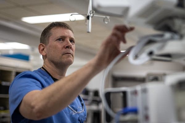 A man stands at a medical device