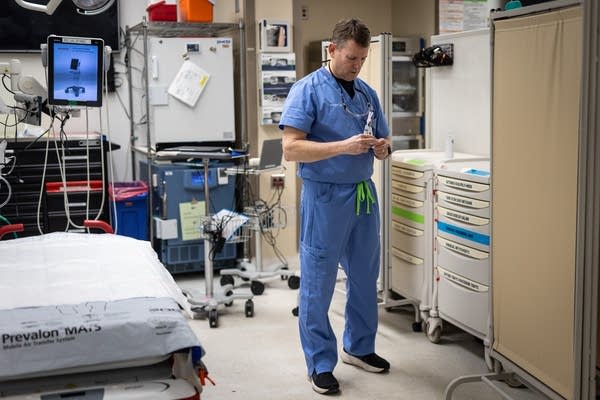 A doctor holds a syringe