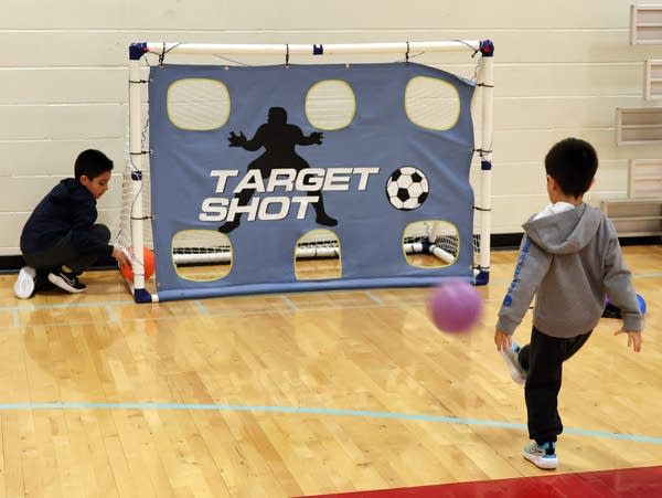 a boy kicks a ball 