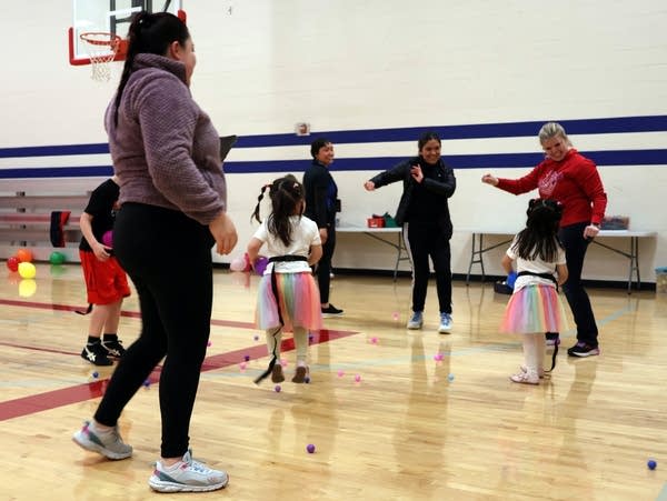 a group of women and children dance