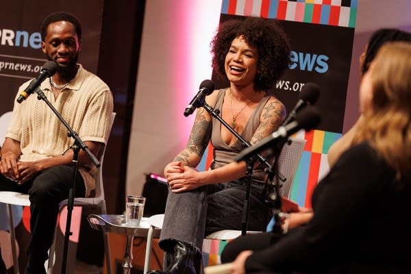 A woman talks on a panel