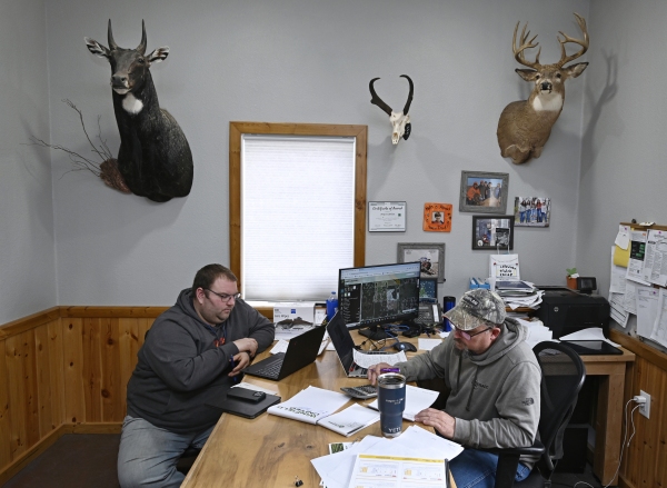 WIMBLEDON, ND - March 07, 2025: Justin Sherlock (L) and agronomist, Royce Carlson, meet in CarlsonÕs office to review SherlockÕs fertilizer needs for the 2025 planting season. Sherlock grows soybeans, corn and edible beans on his farm near Wimbledon, ND. North Dakota farmers are worried about looming tariffs and a possible trade war with China in the coming months.