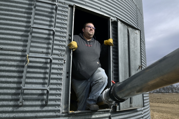  Justin Sherlock transferring corn from a storage bin to a grain truck on his farm