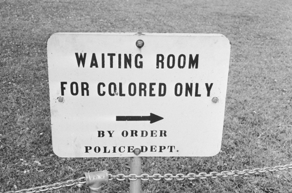 A sign in Jackson, Miss. in May 1961 reads, "Waiting Room for Colored Only" and has an arrow pointing the way. 