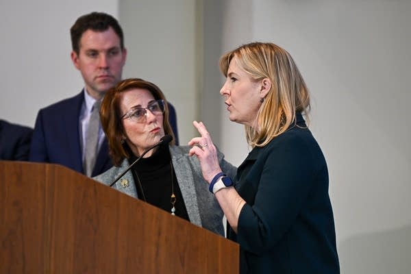 A politician speaks behind a podium.