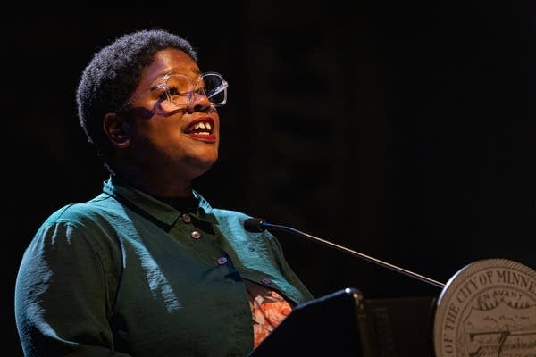 A woman performs a poem