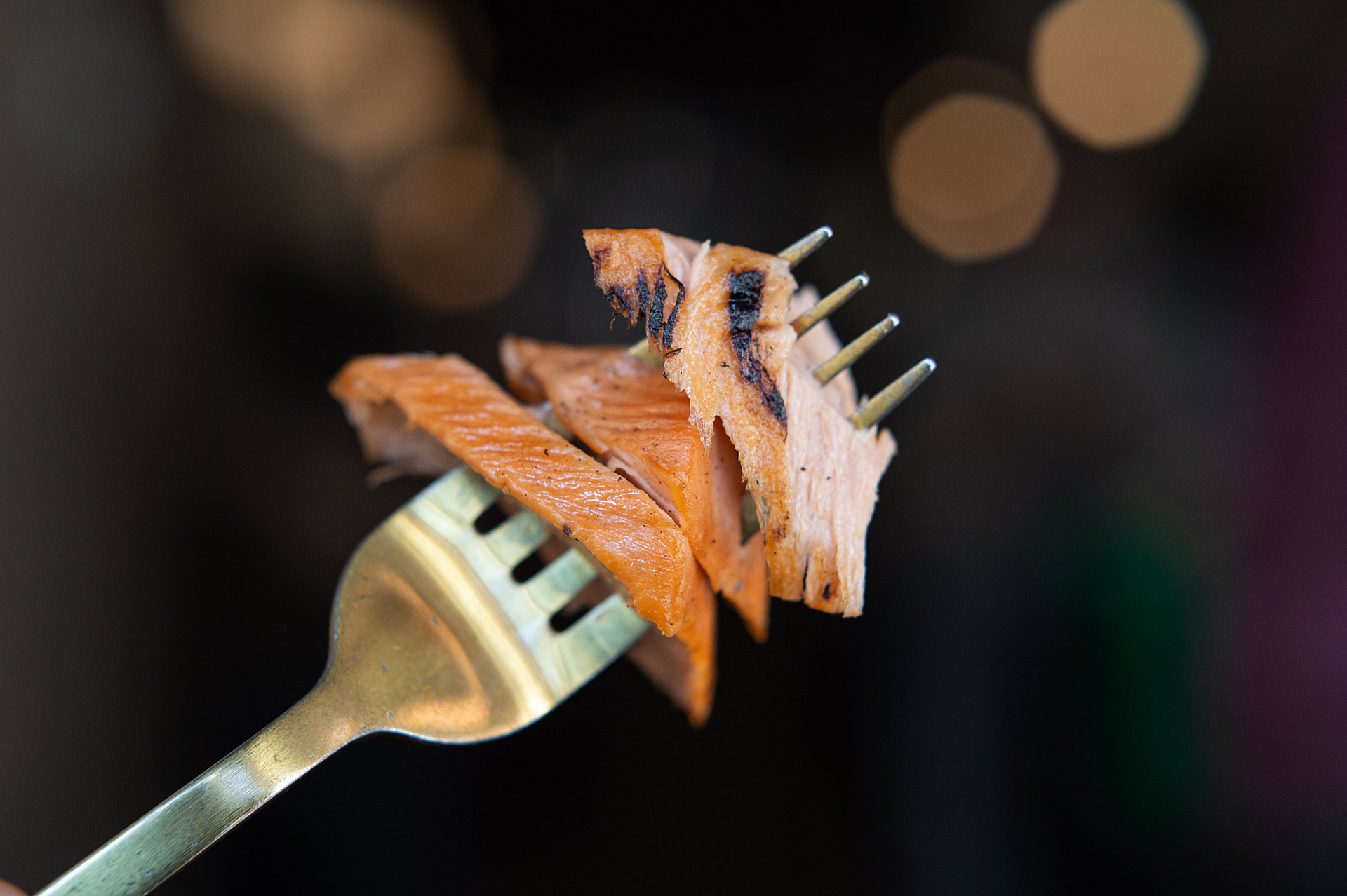 A close-up of pieces of plant-based salmon on a fork.