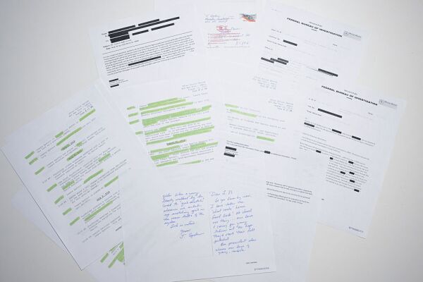 This photo illustration shows a new batch of files released in December by the U.S. government in relation to the late sex offender Jeffrey Epstein. A first batch was made public December 19, 2025 amid fierce criticism that the US Justice Department was deliberately slow-walking the release and excluding any references to US President Donald Trump. The latest slew of documents contains 8,000 files, including hundreds of videos or audio recordings. This includes surveillance footage from August 2019, the month Epstein was found dead in his jail cell -- and declared to have committed suicide. (Photo by AFP via Getty Images)