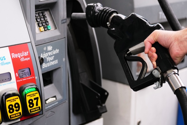 A customer fuels up with regular gasoline priced at $5.29 at a Chevron gas station in Bellevue, Wash., Friday, March 13, 2026. 