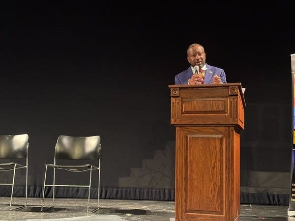man speaks at podium
