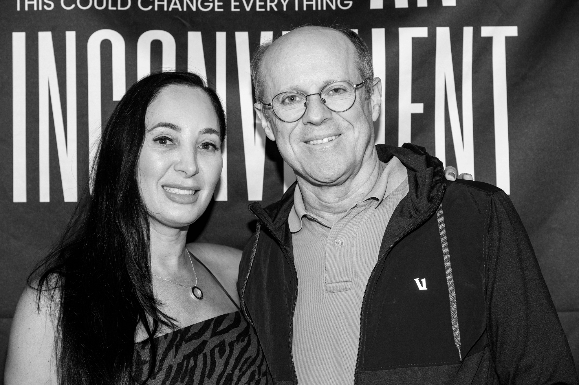 A balding man man and middle-aged woman posing next to one another with smiles.