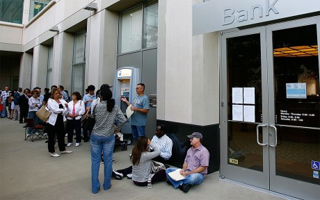 Photo of a long line of customers waiting to get into a Bank, open for the first time since the federal government takeover due to the bank's subprime mortgages with people with bad or no credit history.