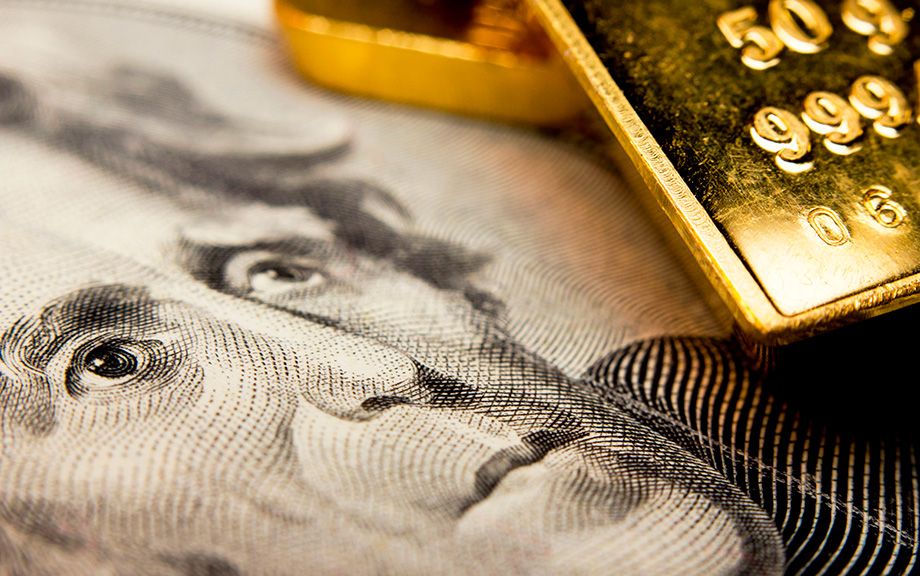 Close-up of a 20-dollar banknote (figuring president Jackson) and a gold bullion