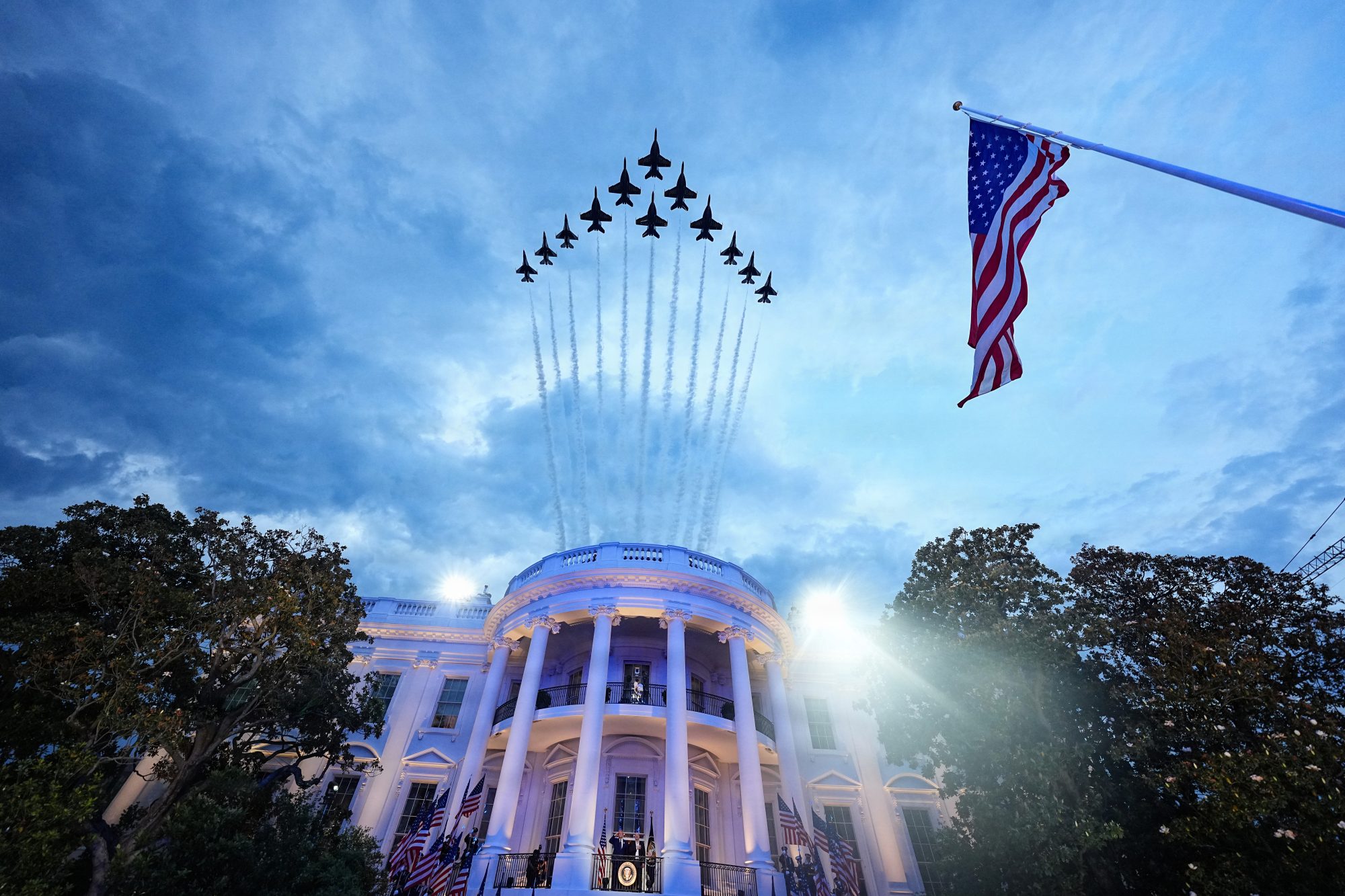 Air Force and Navy jets fly in formation over the White House.