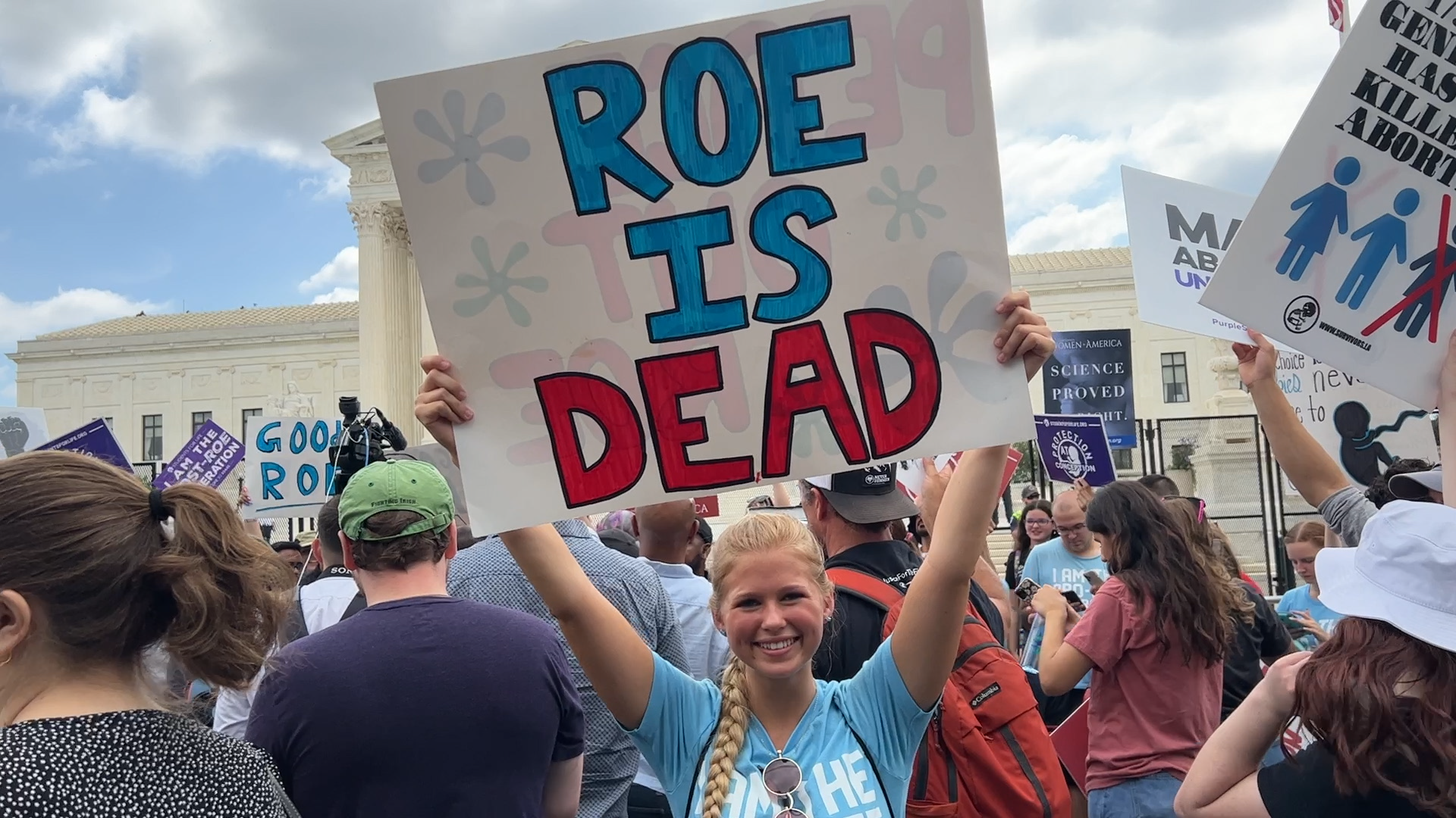 An anti-abortion protestor holds a "ROE IS DEAD" sign outside of the Supreme Courthouse