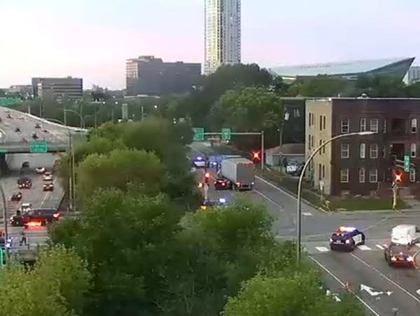 A traffic camera image of a crash involving a car and a semi