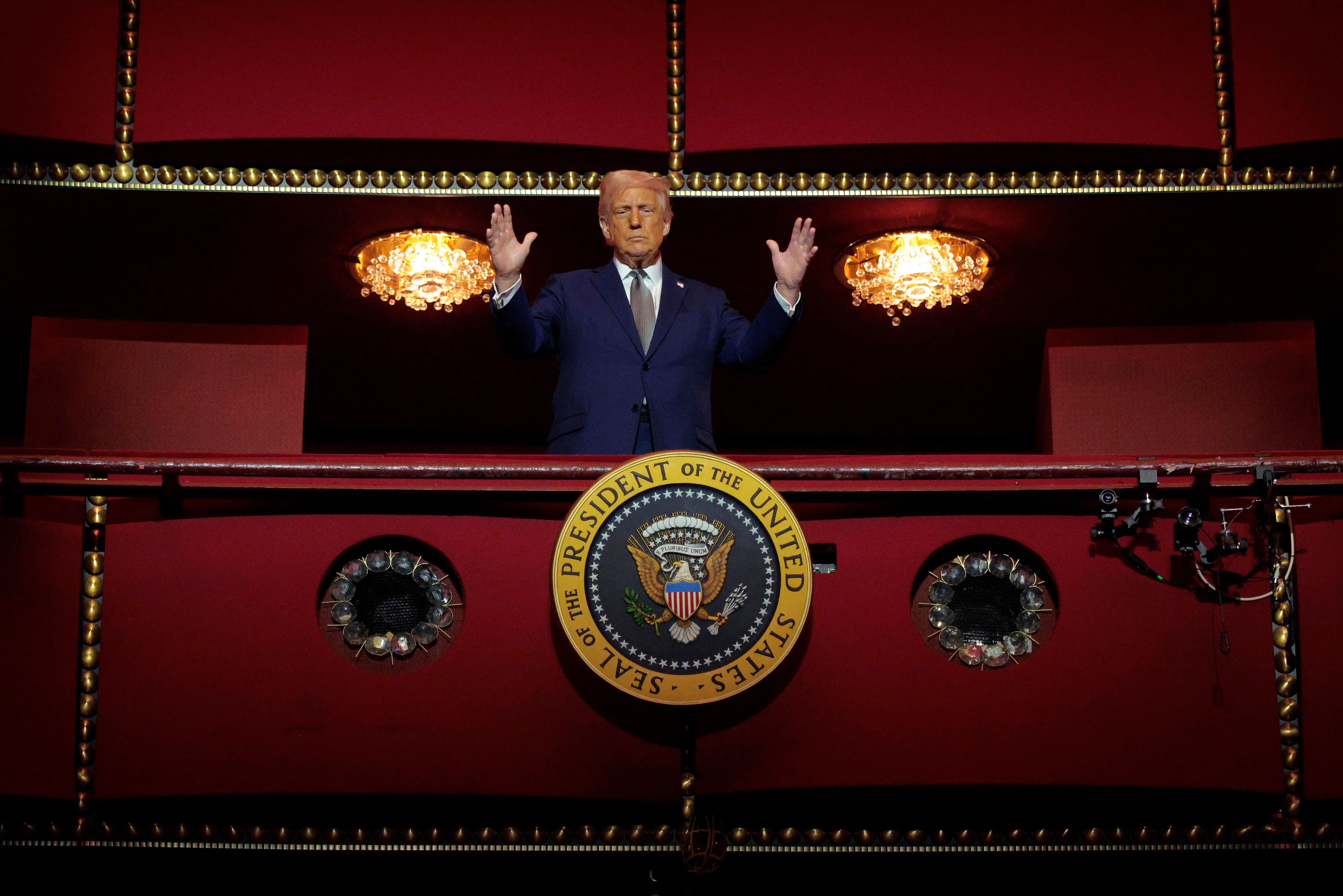 Trump looks down from the Presidential Box in an opera house