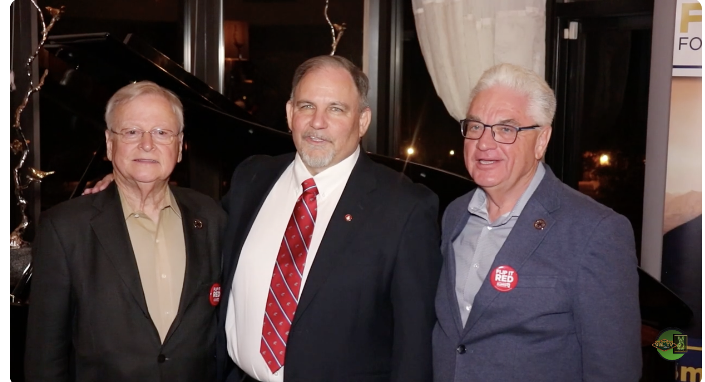 Flipping standing between Tuminello (left) and McDowell (right) at a 2024 campaign event.