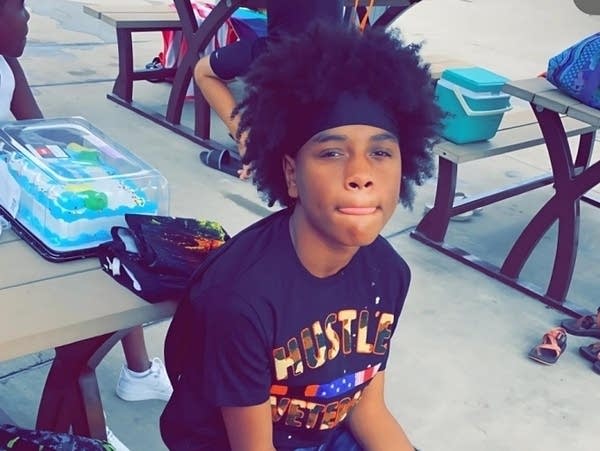 A boy sits on a table