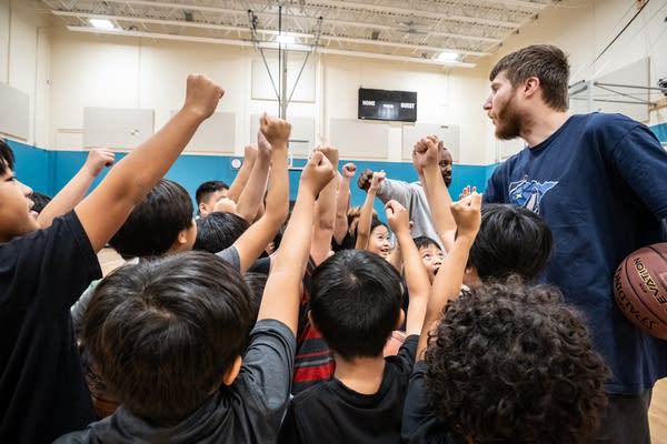 Young boys raise their fists in a cheer.