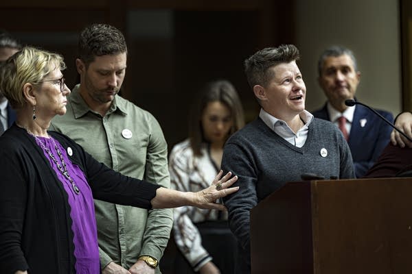 Becca Good speaking at a podium
