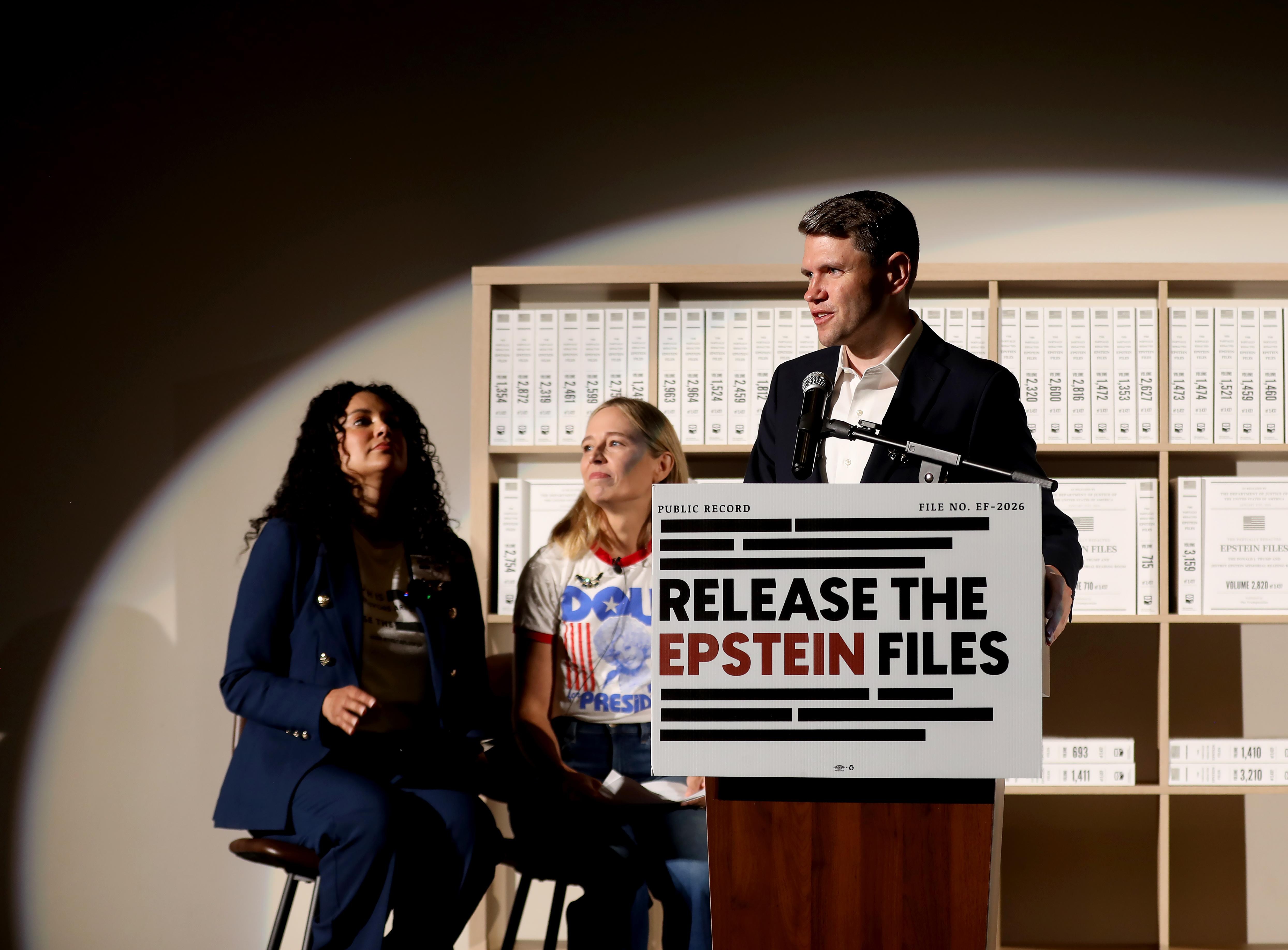 James Talarico stands behind a podium with a sign that reads Release the Epstein files