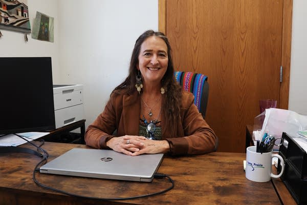 A woman sits at a desk