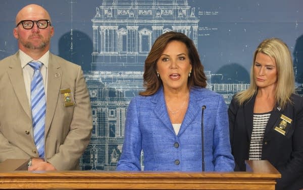 A woman speaks at a podium